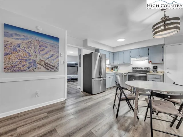 a kitchen with stainless steel appliances a refrigerator and a stove top oven