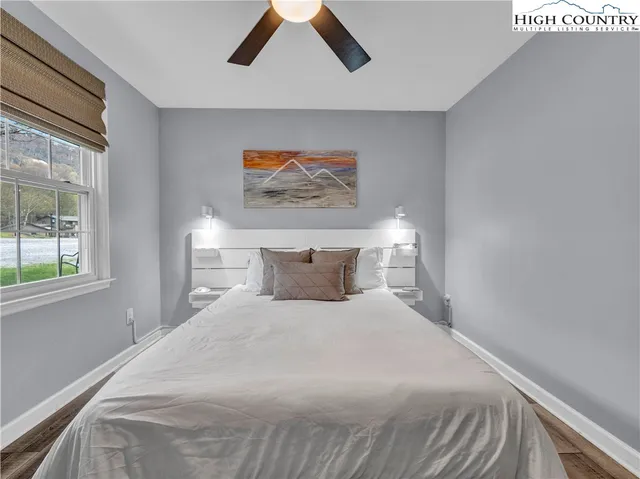 a bedroom with a large bed and a window