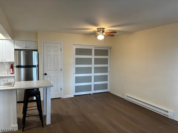 a view of an empty room with a kitchen