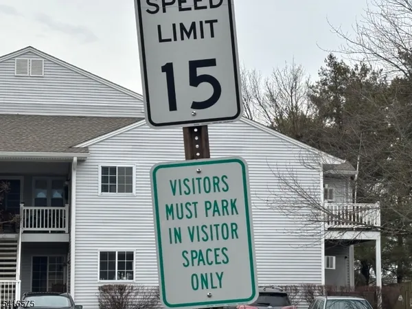 a front view of a house with a sign board