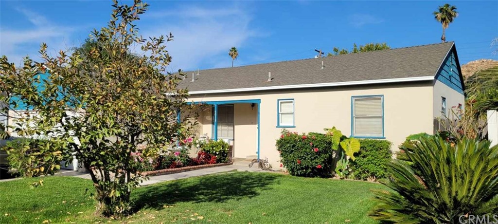 6018 Riverside Avenue Riverside, CA 92506 - Photo 1 of 1 a house that has a tree in front of it