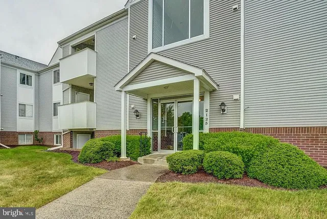 a view of a house with a yard and plants