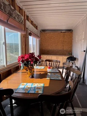 a view of a dining room with furniture and chandelier
