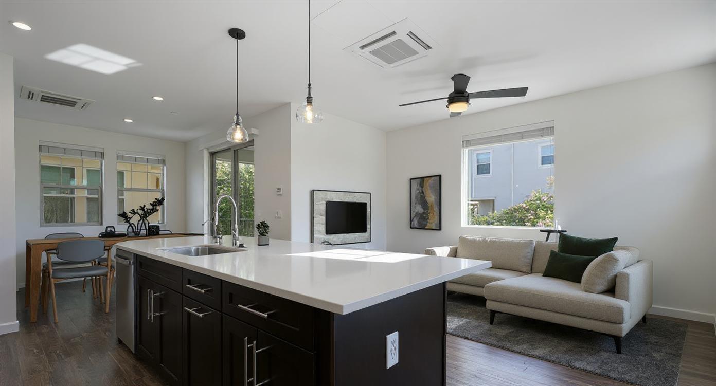 2643 Cleat Lane, Unit 34B Sacramento, CA 95818 - Photo 2 of 39 a living room with stainless steel appliances kitchen island a couches and a chandelier