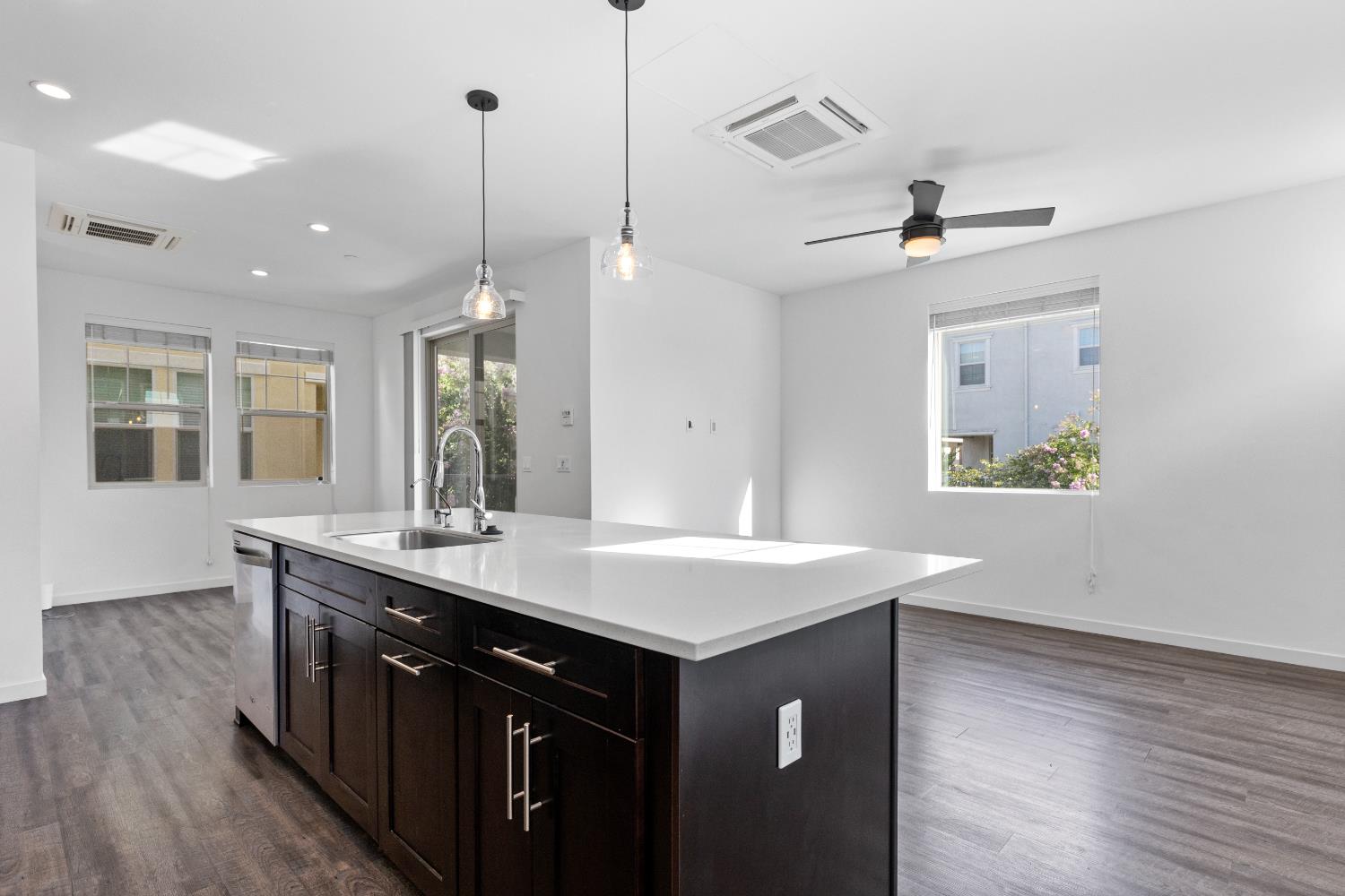 2643 Cleat Lane, Unit 34B Sacramento, CA 95818 - Photo 5 of 39 a kitchen with a sink a window and wooden floor