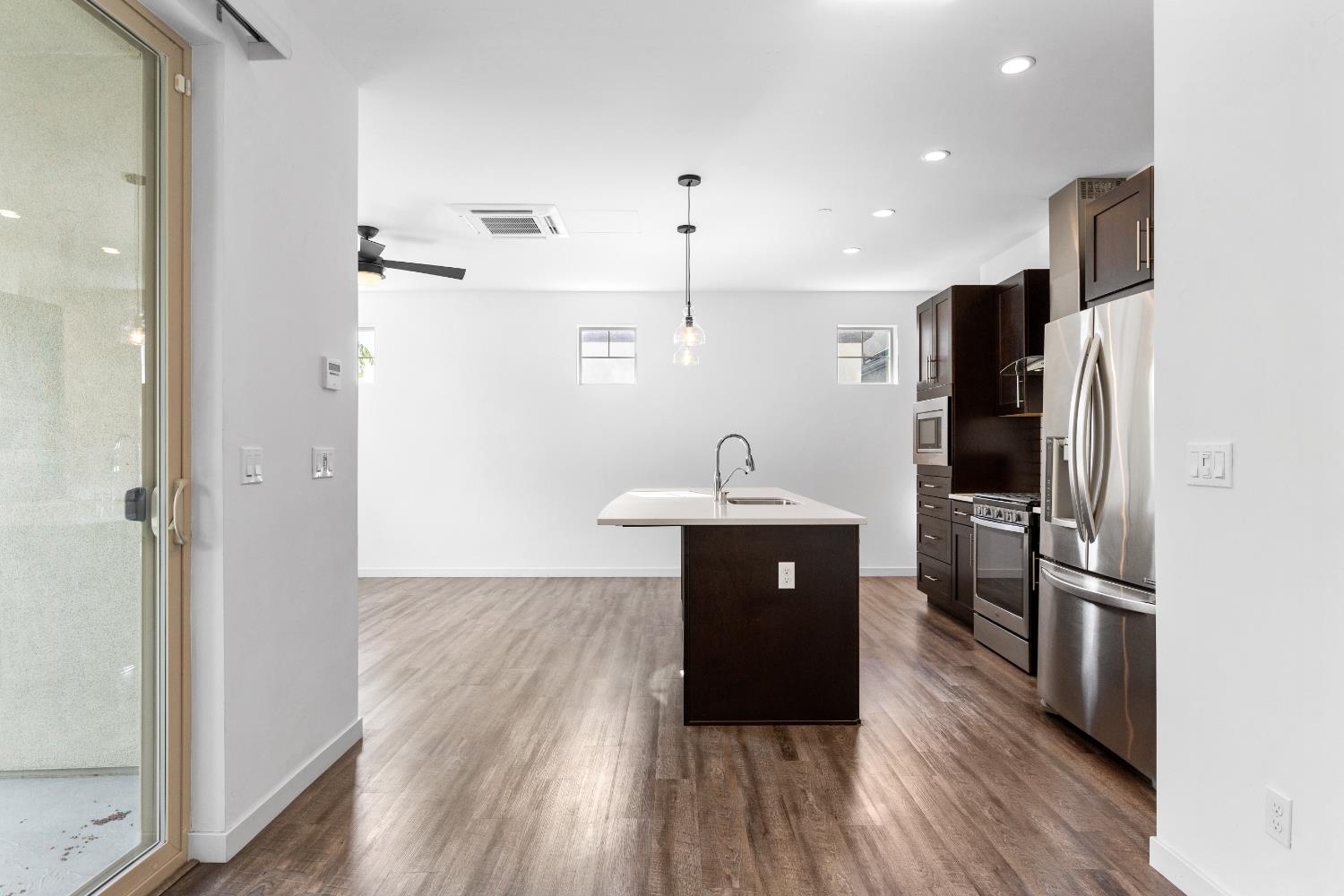 2643 Cleat Lane, Unit 34B Sacramento, CA 95818 - Photo 8 of 39 a kitchen with stainless steel appliances a refrigerator and a sink