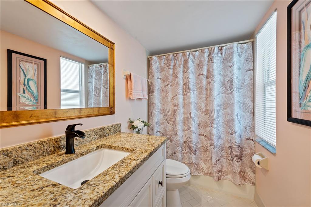 448 Teryl Road, Unit 2341 Naples, FL 34112 - Photo 15 of 32 a bathroom with a granite countertop sink and a mirror