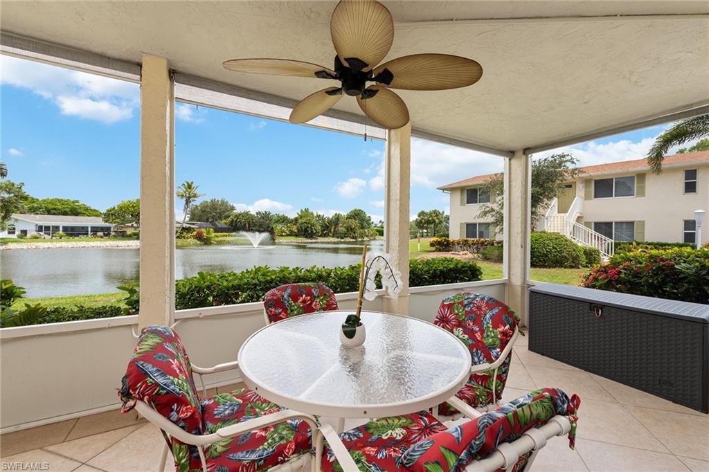 448 Teryl Road, Unit 2341 Naples, FL 34112 - Photo 17 of 32 a living room with patio furniture and a floor to ceiling window