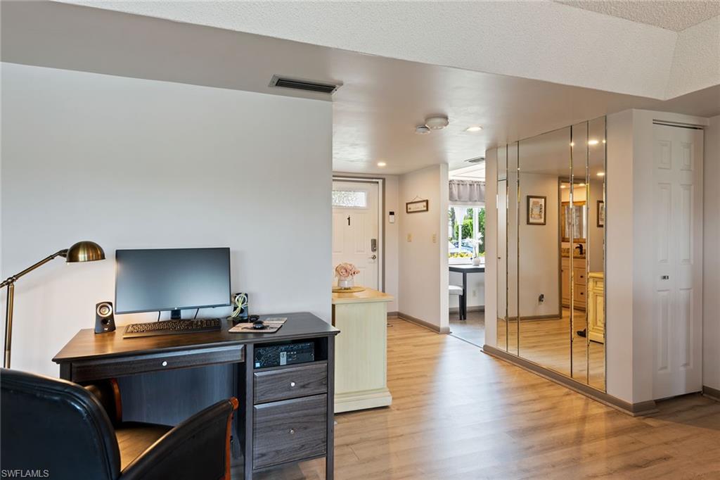 448 Teryl Road, Unit 2341 Naples, FL 34112 - Photo 19 of 32 a view of a workspace with wooden floor
