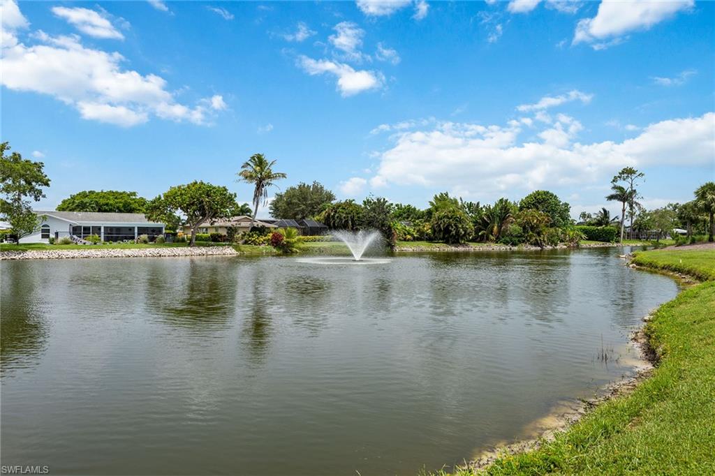 448 Teryl Road, Unit 2341 Naples, FL 34112 - Photo 20 of 32 a view of a lake with houses in the back