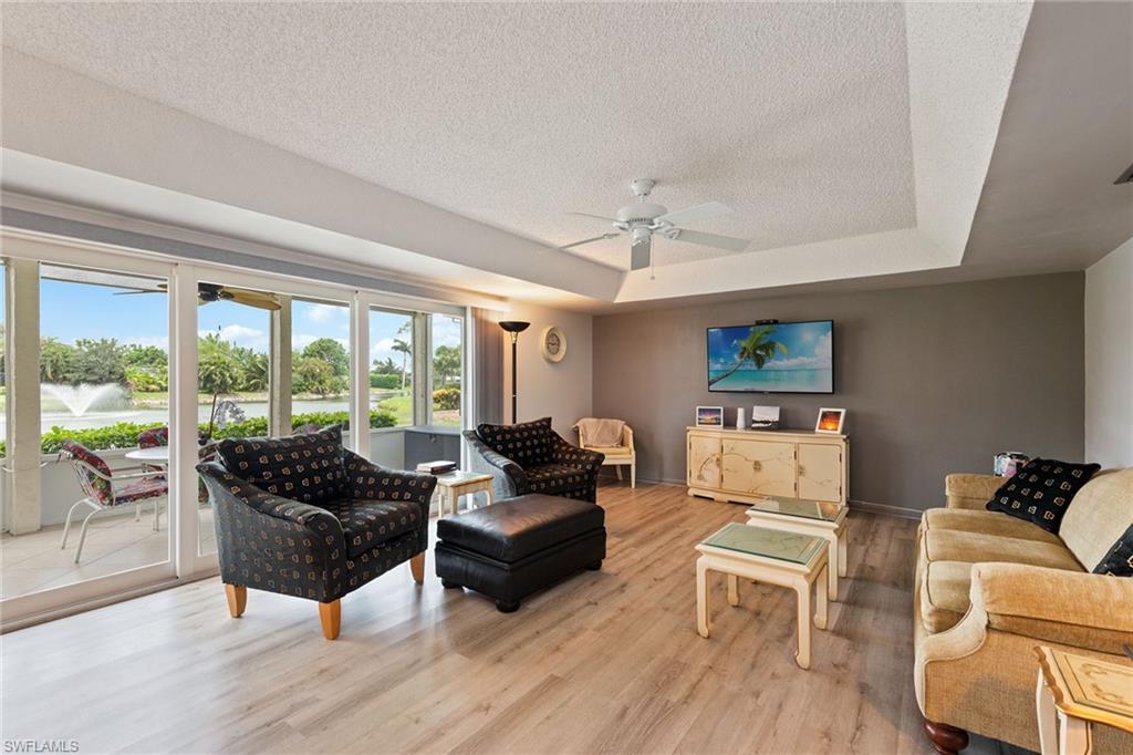 448 Teryl Road, Unit 2341 Naples, FL 34112 - Photo 2 of 32 a living room with furniture and a large window