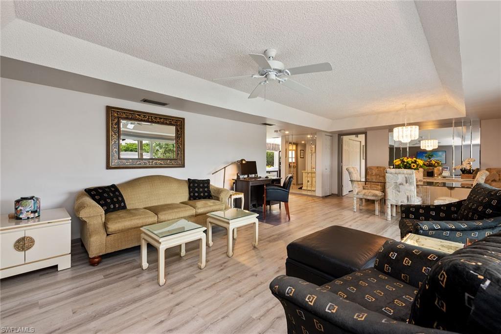 448 Teryl Road, Unit 2341 Naples, FL 34112 - Photo 3 of 32 a living room with furniture and wooden floor