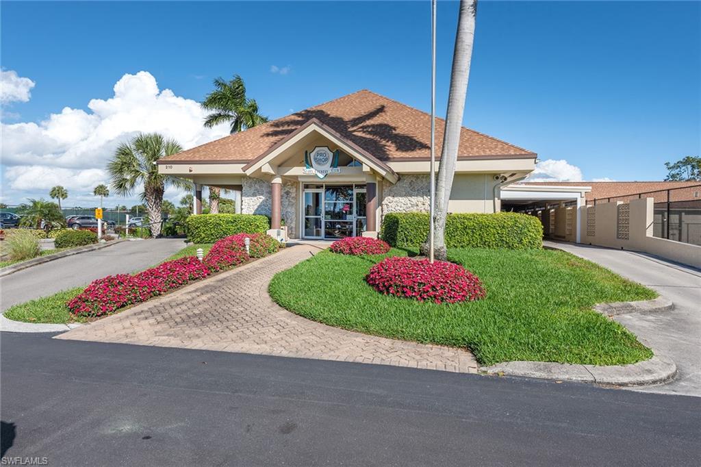 448 Teryl Road, Unit 2341 Naples, FL 34112 - Photo 31 of 32 a view of a house with a small yard and a yard