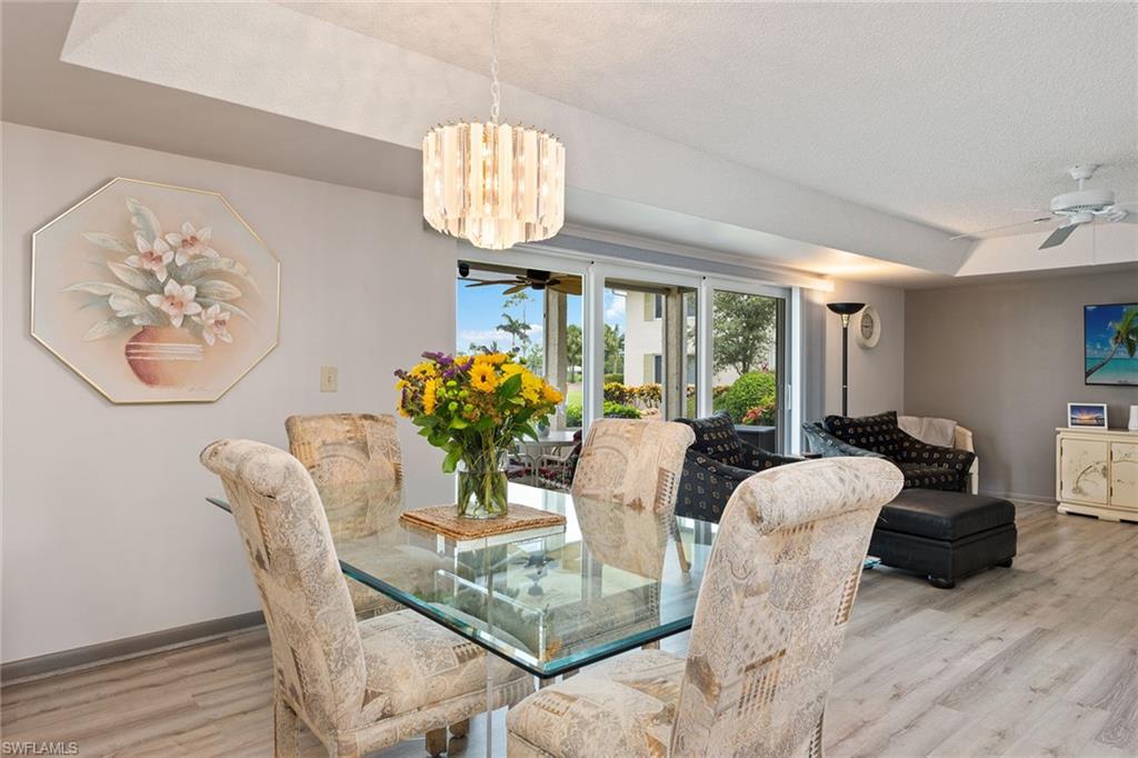 448 Teryl Road, Unit 2341 Naples, FL 34112 - Photo 6 of 32 a dining room with furniture a livingroom and chandelier