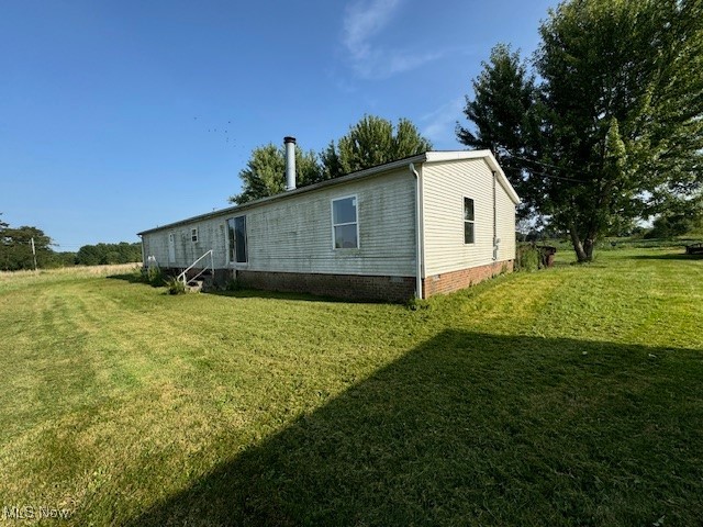 8089 Giddings Road Rootstown, OH 44272 - Photo 2 of 8 View of side of property featuring a yard