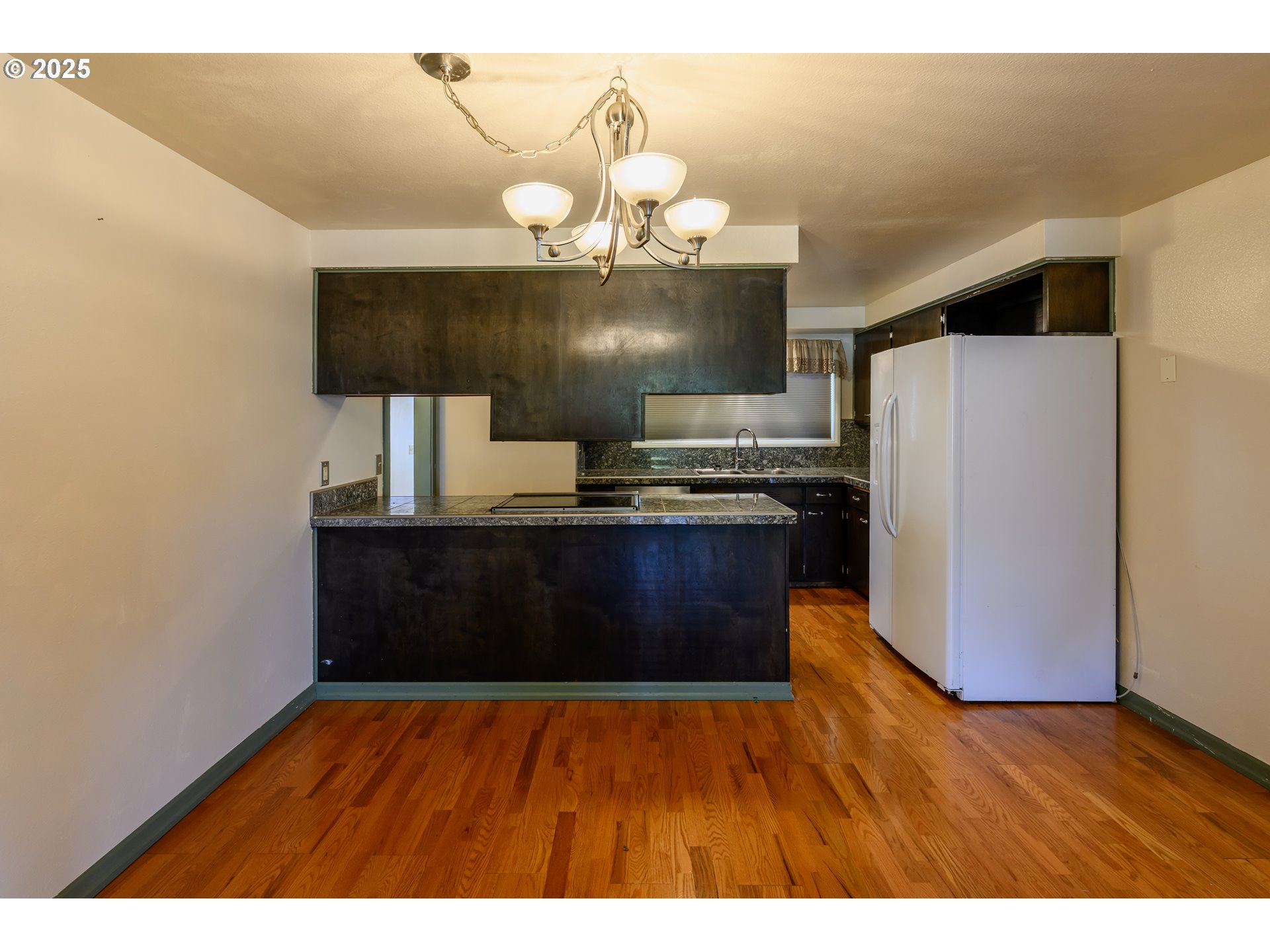 3854 Jasper Road Springfield, OR 97478 - Photo 12 of 33 a kitchen with stainless steel appliances granite countertop a refrigerator a stove and a wooden floors