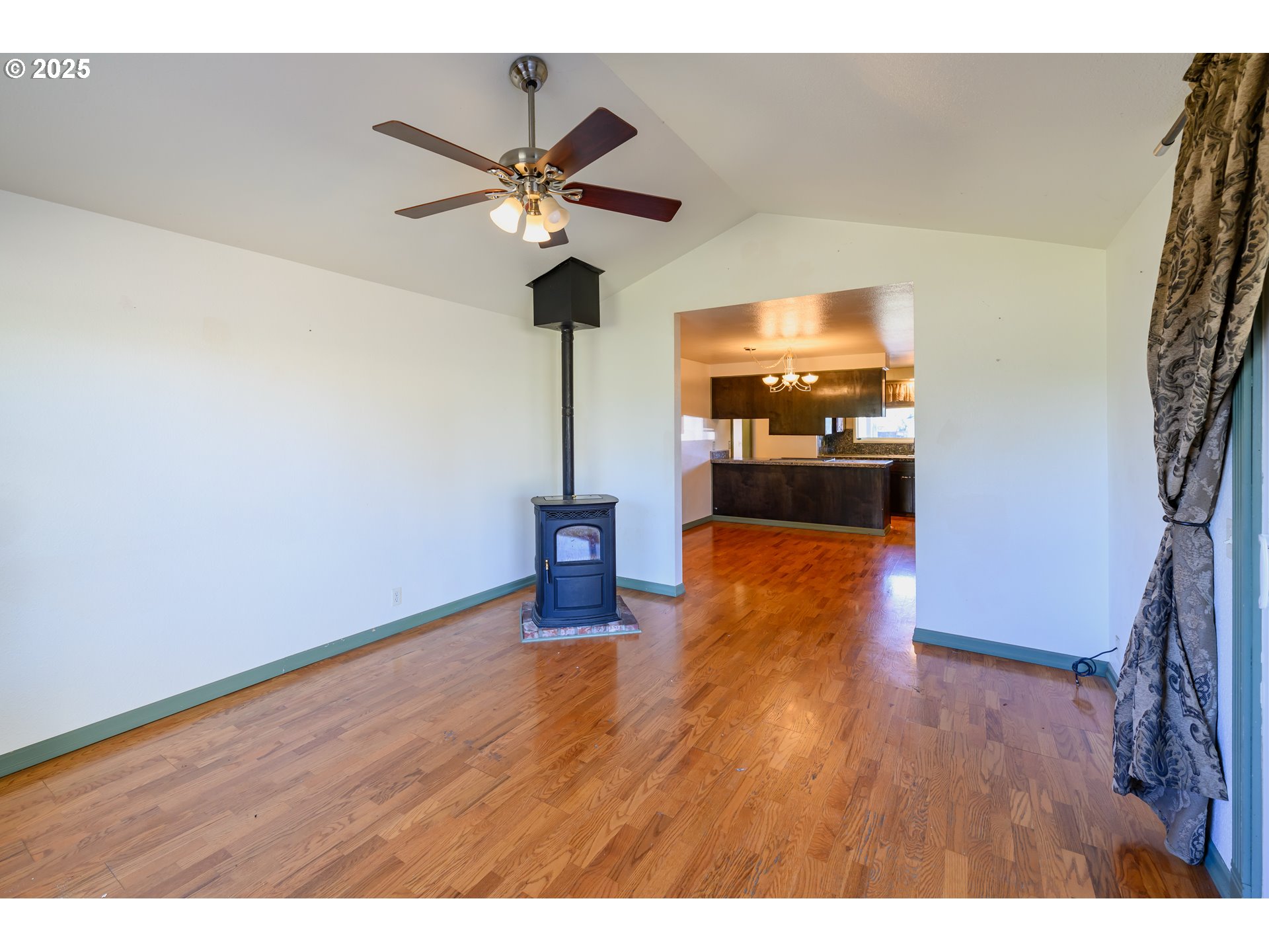 3854 Jasper Road Springfield, OR 97478 - Photo 15 of 33 a view of a livingroom with a chandelier fan and wooden floor