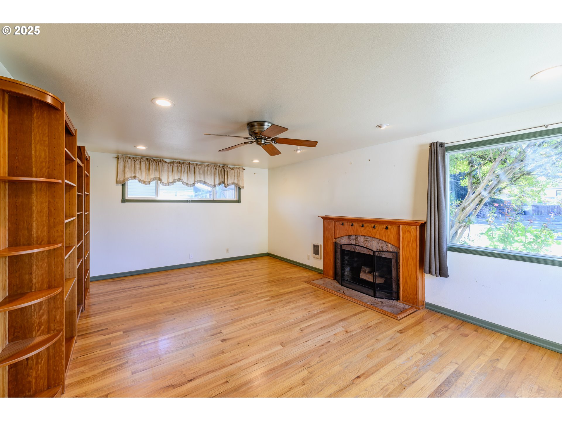 3854 Jasper Road Springfield, OR 97478 - Photo 4 of 33 a view of an empty room with a window and fireplace