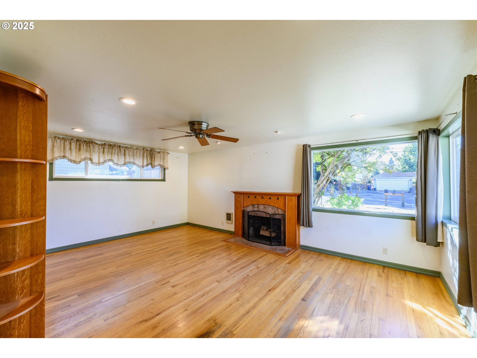3854 Jasper Road Springfield, OR 97478 - Photo 5 of 33 a view of empty room with a fireplace and wooden floor