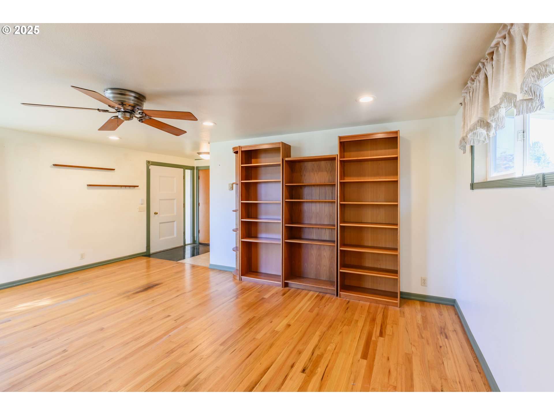 3854 Jasper Road Springfield, OR 97478 - Photo 6 of 33 a view of an empty room with a window and wooden floor
