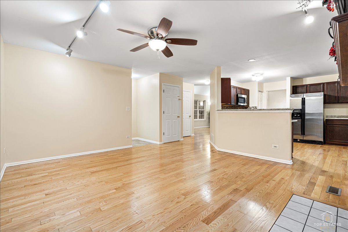 7 Eagle Court Streamwood, IL 60107 - Photo 14 of 31 an empty room with wooden floor and appliances