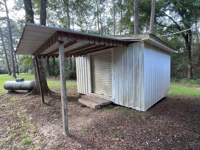 a view of outdoor space with garden and trees