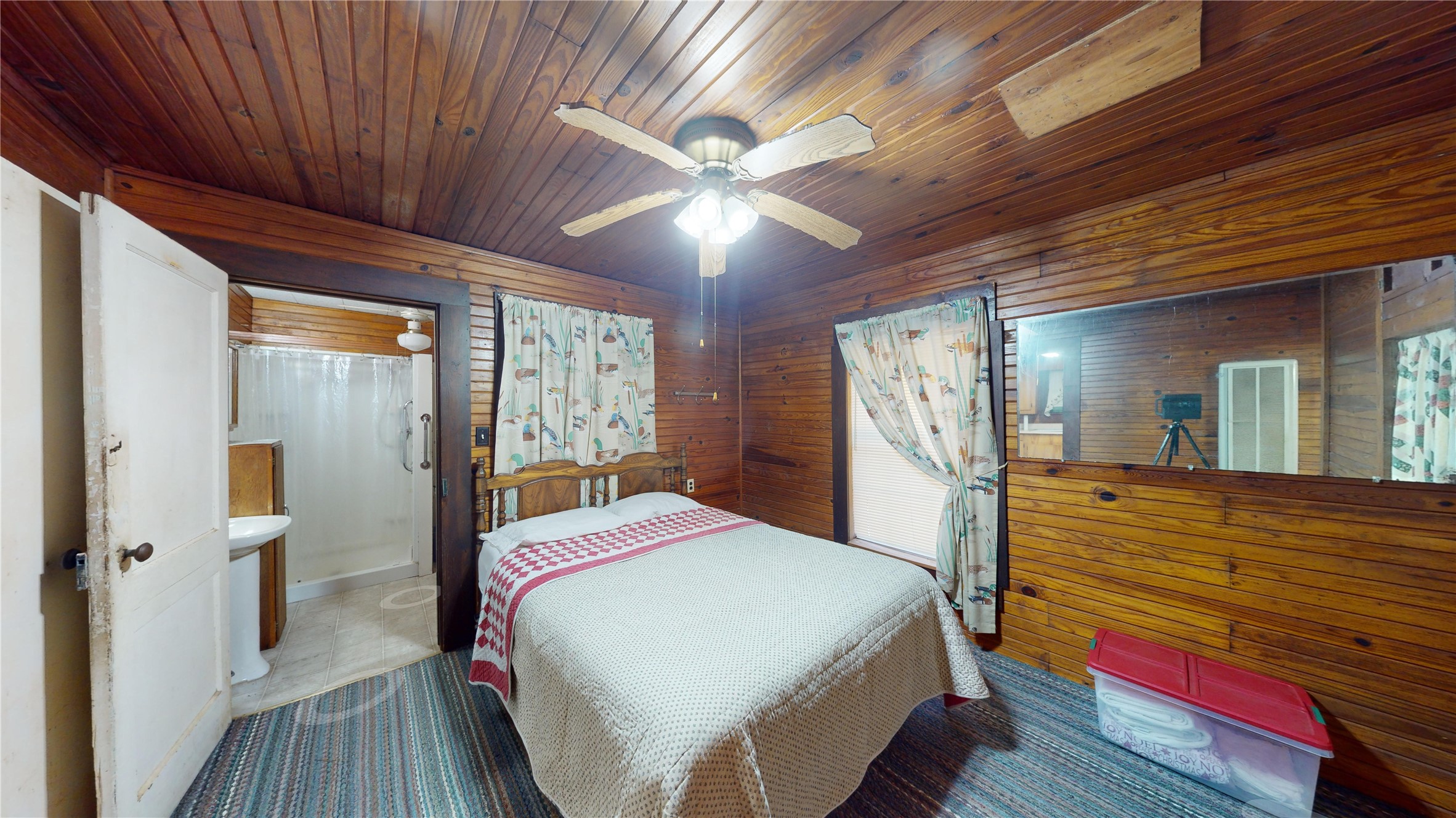 18157 State Highway 87 Call, TX 75933 - Photo 9 of 39 a bedroom with a bed and large mirror with wooden floor