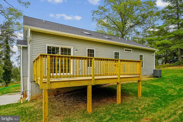 a view of balcony with wooden floor and fence