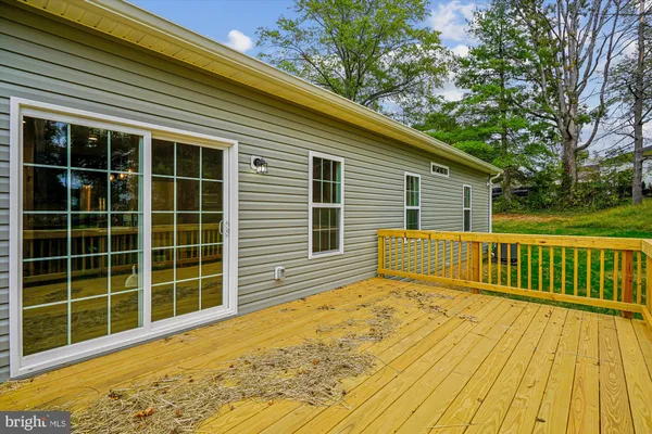 an empty room with a ceiling fan and carpet