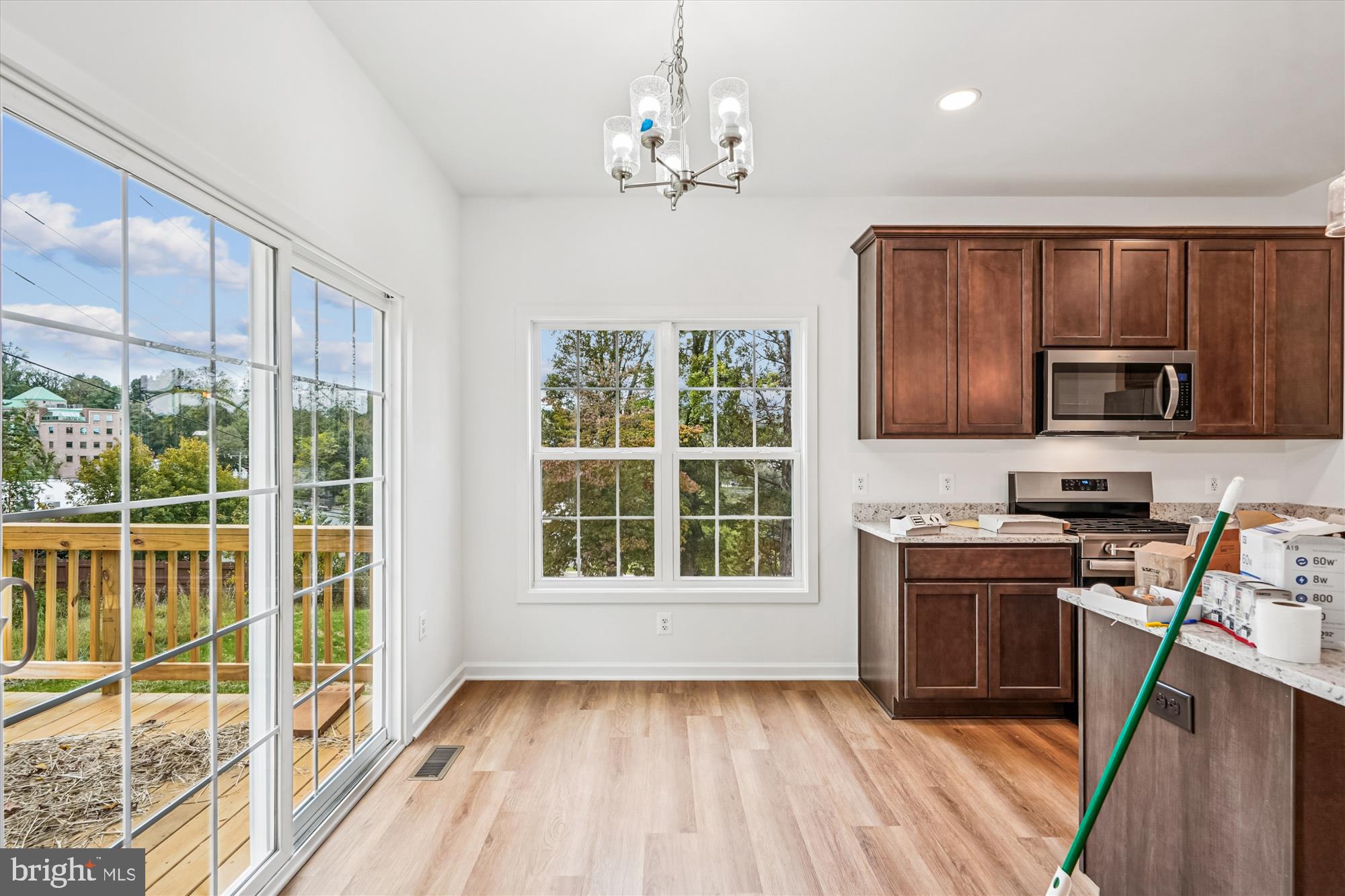 1 Eggbornsville Road Rixeyville, VA 22737 - Photo 49 of 66 a kitchen with stainless steel appliances granite countertop a stove top oven a sink dishwasher a refrigerator and a fireplace with wooden floor