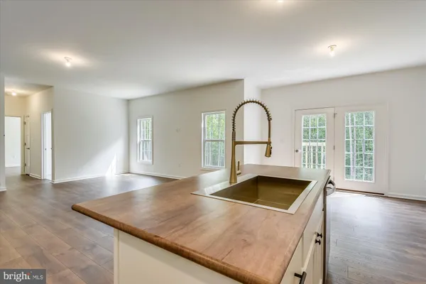 a kitchen with stainless steel appliances granite countertop a refrigerator a sink a stove a microwave and cabinets