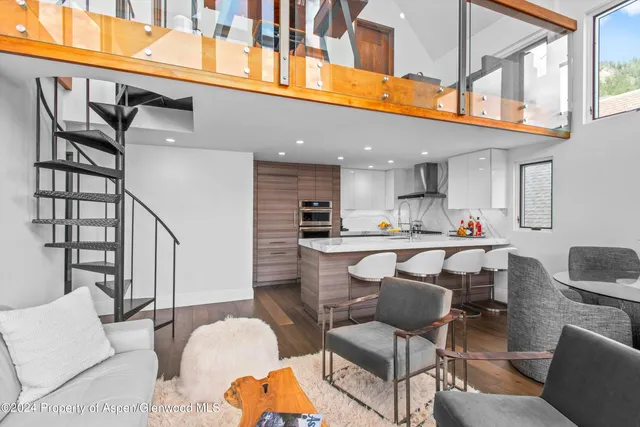 a dining room with furniture a rug and a window