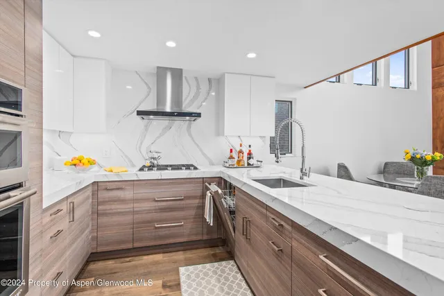 a kitchen with granite countertop kitchen island stainless steel appliances a sink and counter space