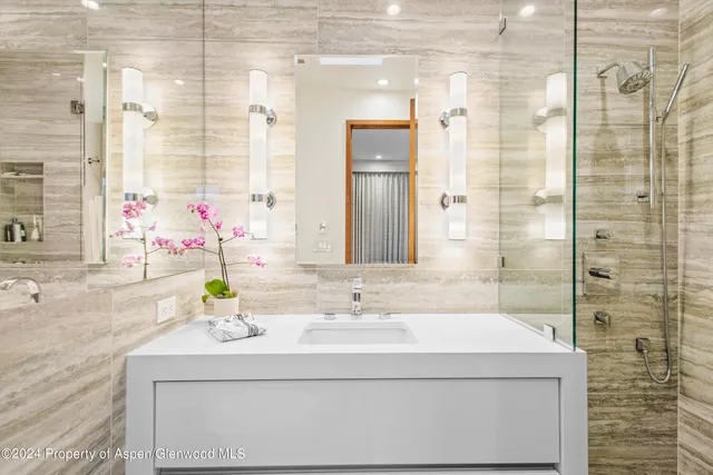 a bathroom with a sink and a mirror