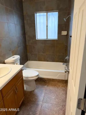 a bathroom with a toilet and a bathtub