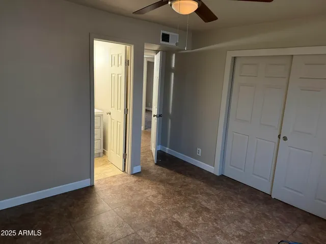 an empty room with closet area