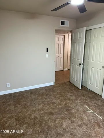 an empty room with windows and entrance