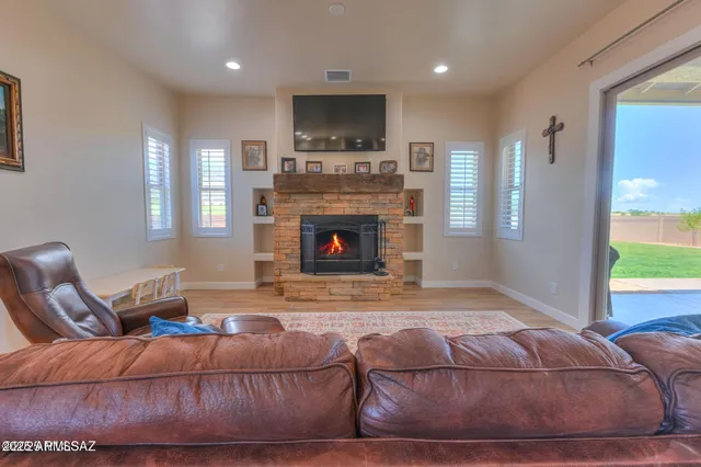 a living room with furniture fireplace and flat screen tv