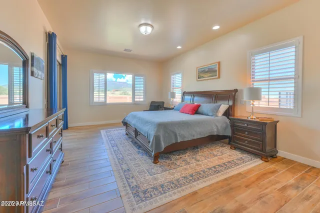 a bedroom with a bed and wooden floor