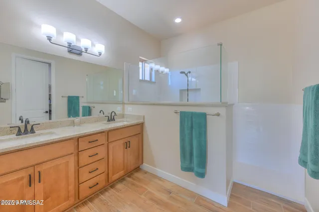a bathroom with a double vanity sink and a mirror