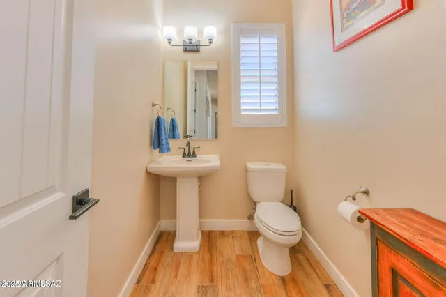 a bathroom with a sink a toilet and mirror