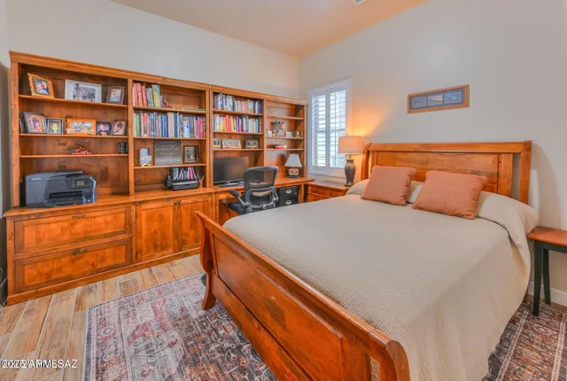 a bed room with a bed and a book shelf
