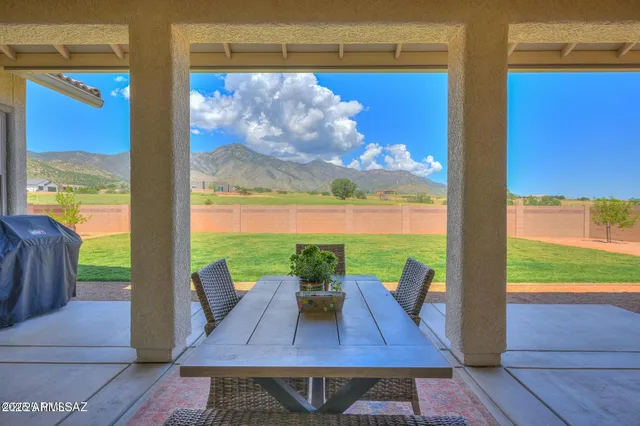 a view of a patio with lawn chairs floor to ceiling window and an outdoor space