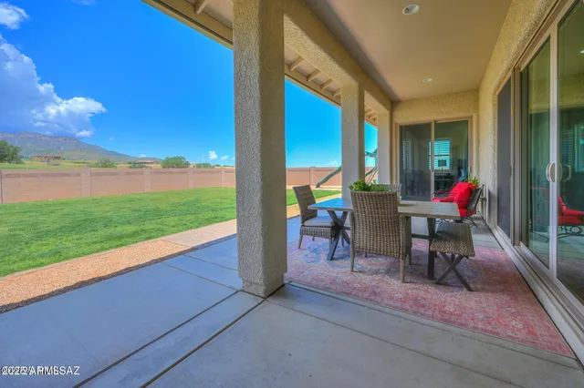 a view of a patio with a table and chairs