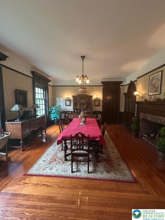 1170 Mosser Road Breinigsville, PA 18031 - Photo 13 of 19 Ornate millwork and a brick fireplace highlight this sophisticated dining room, perfect for elegant entertaining.