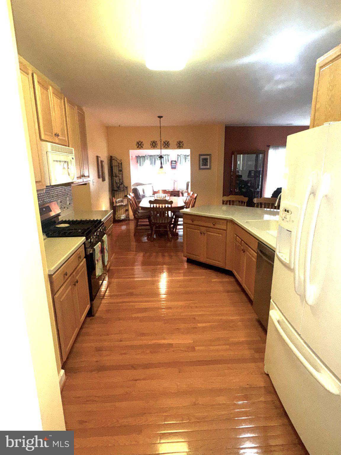 231 Foxglove Loop Bear, DE 19701 - Photo 8 of 30 a kitchen with stainless steel appliances granite countertop a stove a sink and a refrigerator