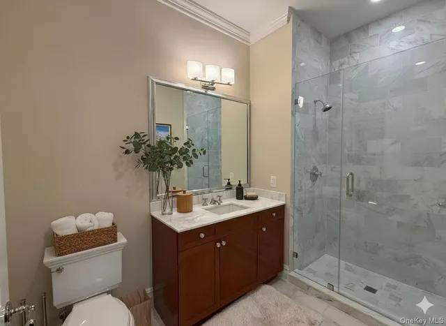 a bathroom with a sink mirror and toilet