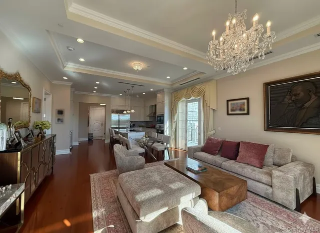 a living room with furniture and a chandelier