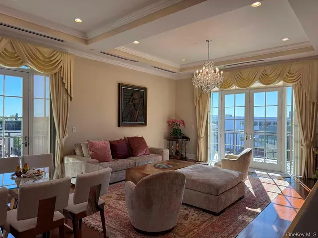 a kitchen with stainless steel appliances granite countertop a stove a sink a refrigerator a microwave oven with a dining table and chairs