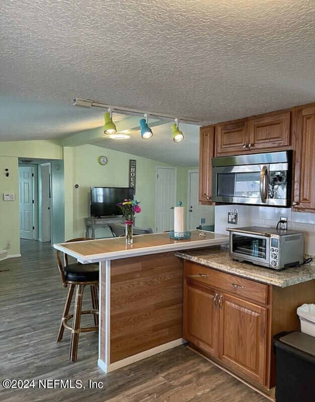 230 Basque Road St. Augustine, FL 32080 - Photo 6 of 11 a kitchen with stainless steel appliances granite countertop a sink a stove counter space and cabinets